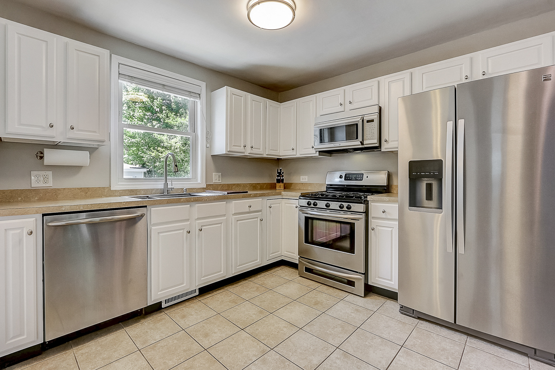 1025 North Main Street Naperville, IL 60563 - Photo 8 of 28 a kitchen with cabinets stainless steel appliances and window