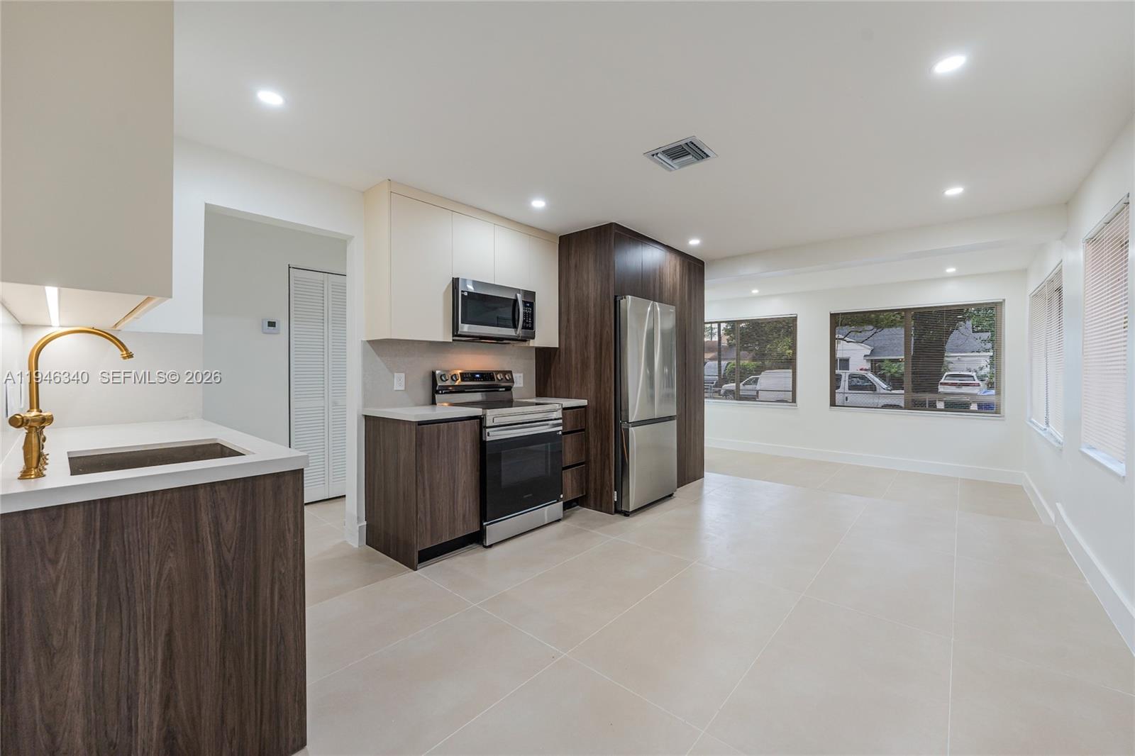 a kitchen with stainless steel appliances a refrigerator and a sink