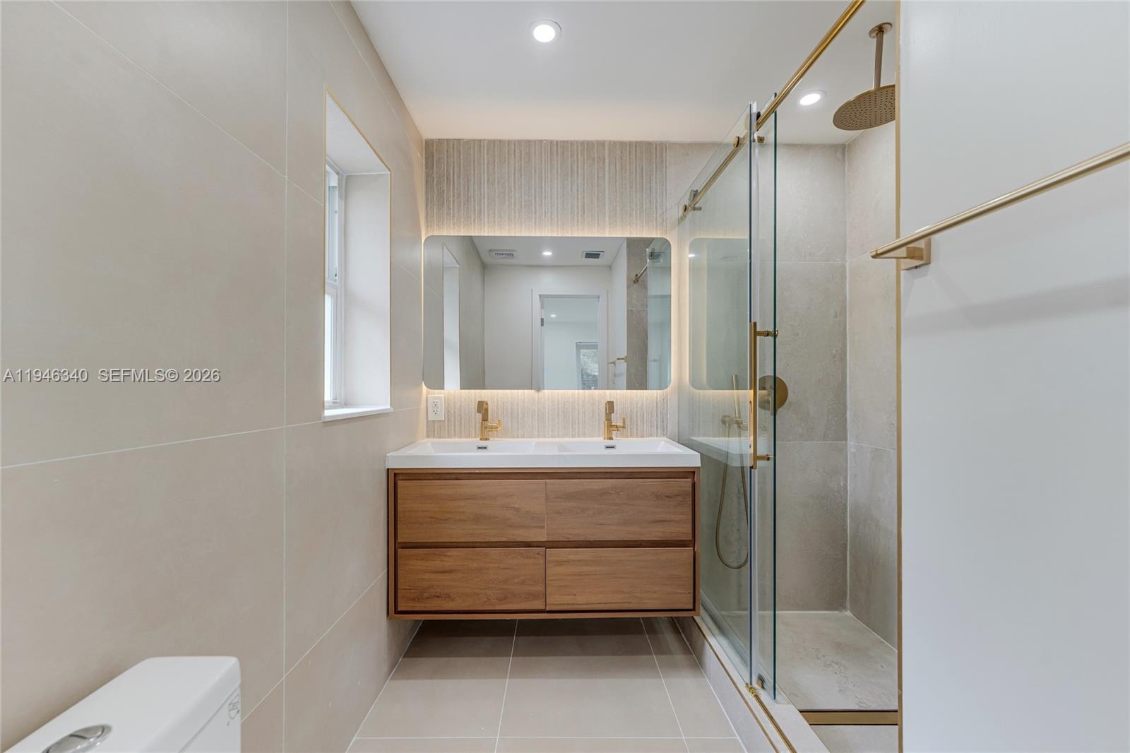 1065 Northwest 50th Street Miami, FL 33127 - Photo 11 of 21 a bathroom with a sink mirror toilet and shower