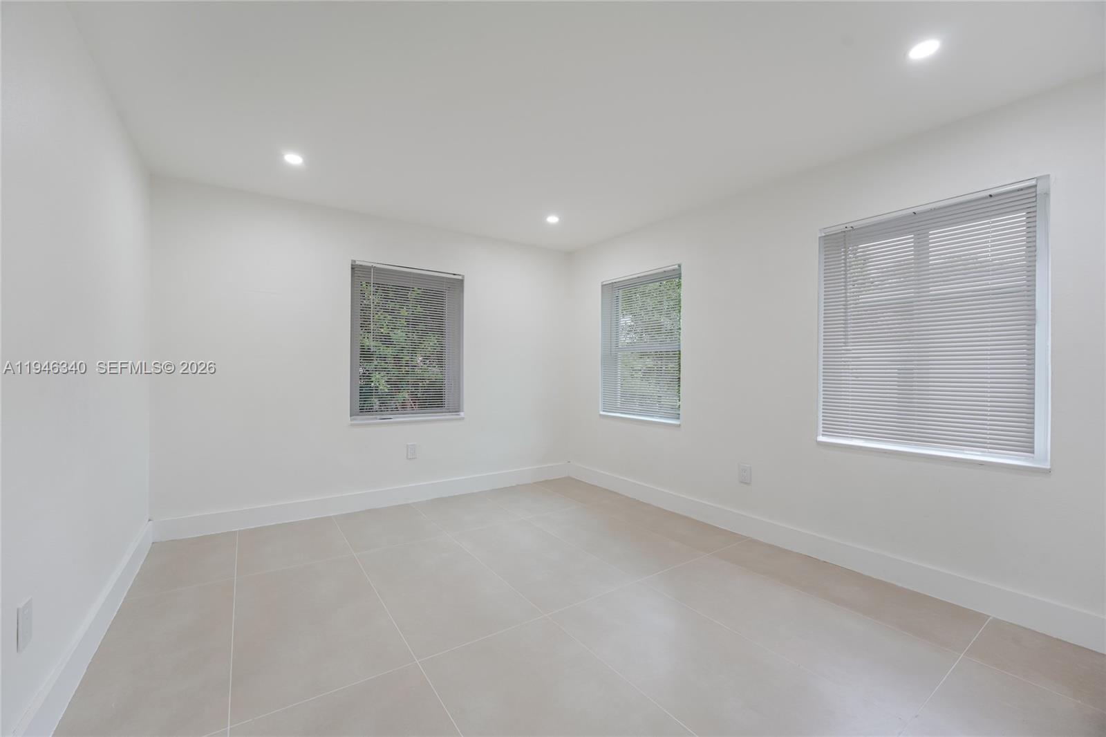1065 Northwest 50th Street Miami, FL 33127 - Photo 14 of 21 an empty room with windows
