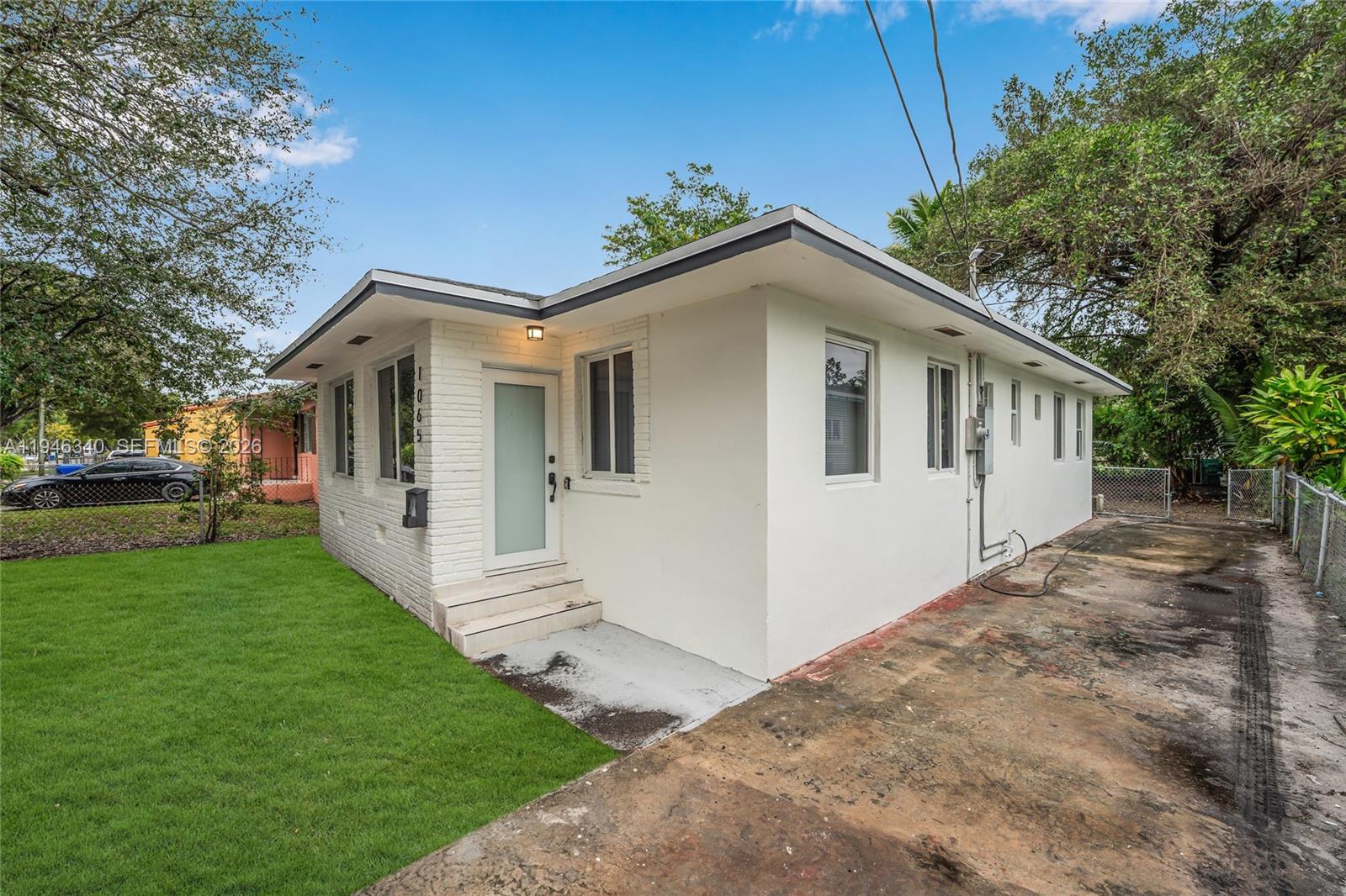 1065 Northwest 50th Street Miami, FL 33127 - Photo 19 of 21 a front view of a house with a yard