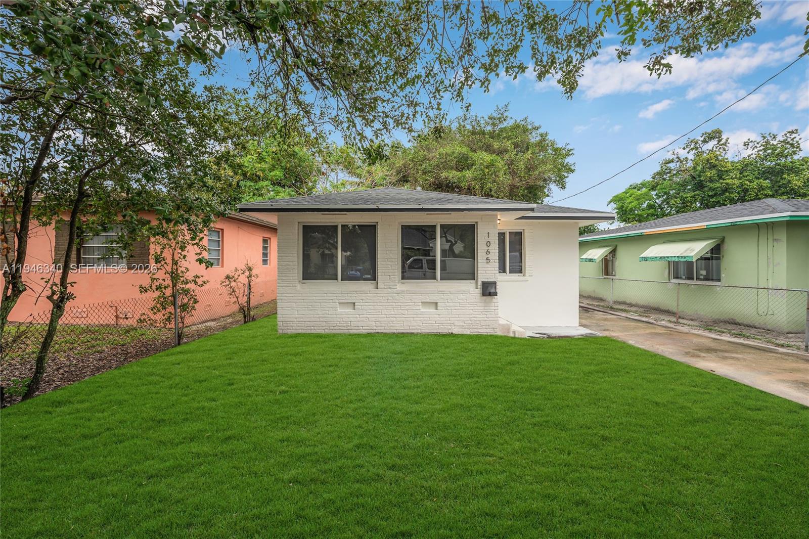 1065 Northwest 50th Street Miami, FL 33127 - Photo 2 of 21 a view of a house with a backyard