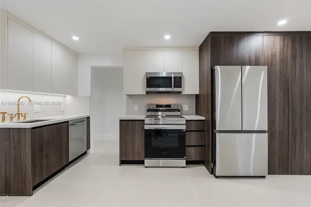 a kitchen with stainless steel appliances a refrigerator stove and microwave