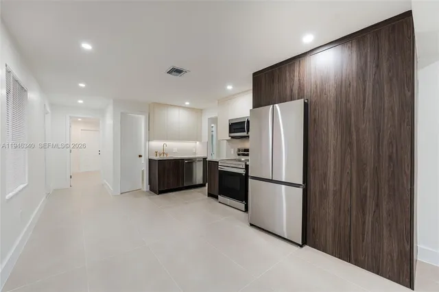 a kitchen with stainless steel appliances a refrigerator and a sink