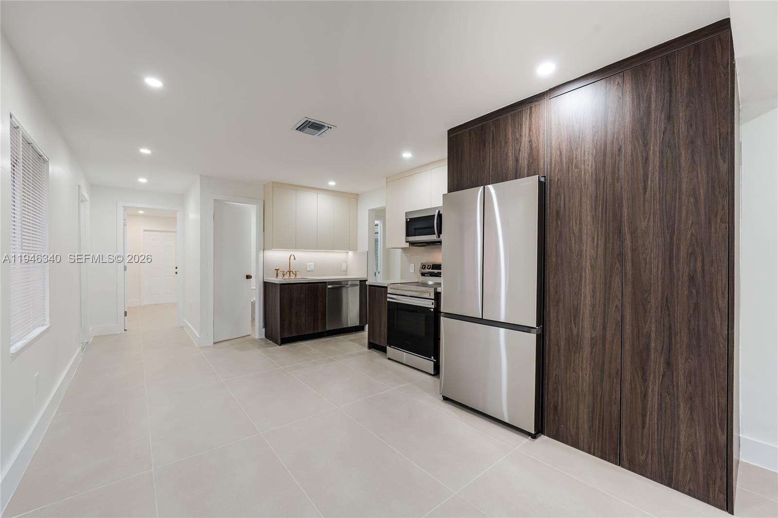 1065 Northwest 50th Street Miami, FL 33127 - Photo 5 of 21 a kitchen with stainless steel appliances a refrigerator and a sink