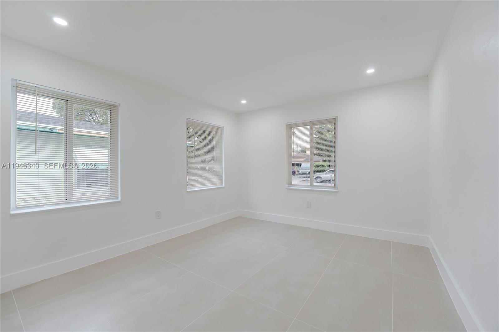 1065 Northwest 50th Street Miami, FL 33127 - Photo 9 of 21 an empty room with windows