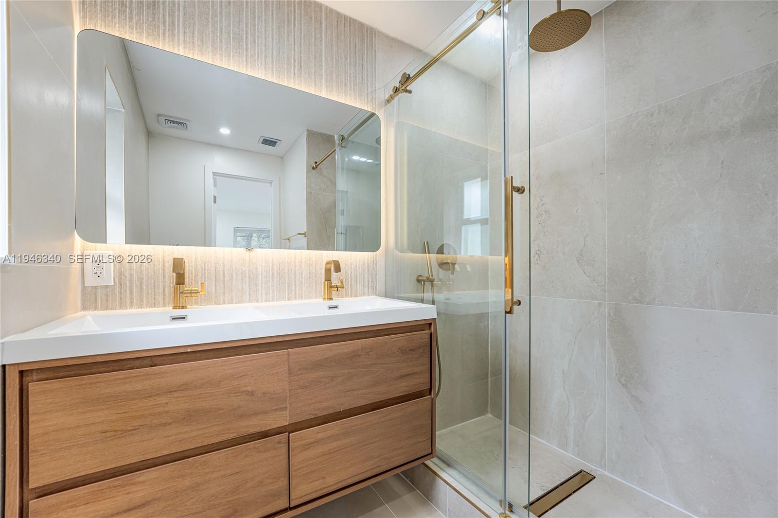 1065 Northwest 50th Street Miami, FL 33127 - Photo 10 of 21 a bathroom with a double vanity sink mirror and shower