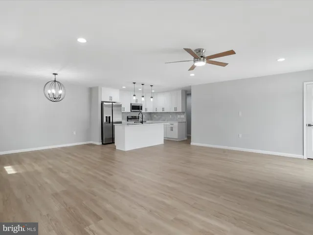 a view of a kitchen with a sink and a stove top oven