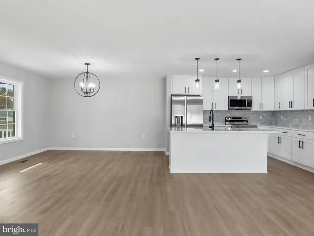 a view of kitchen with granite countertop cabinets and stainless steel appliances