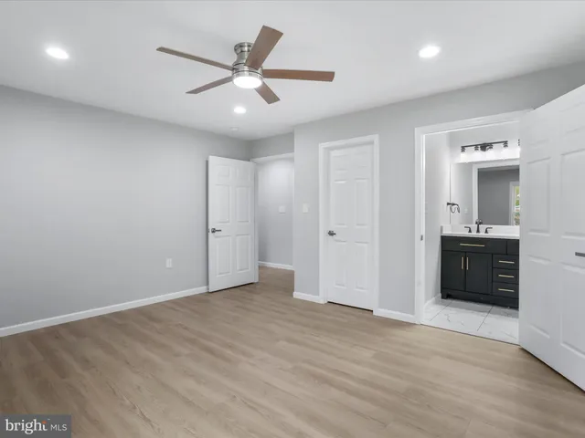 a view of a livingroom with a ceiling fan and wooden floor