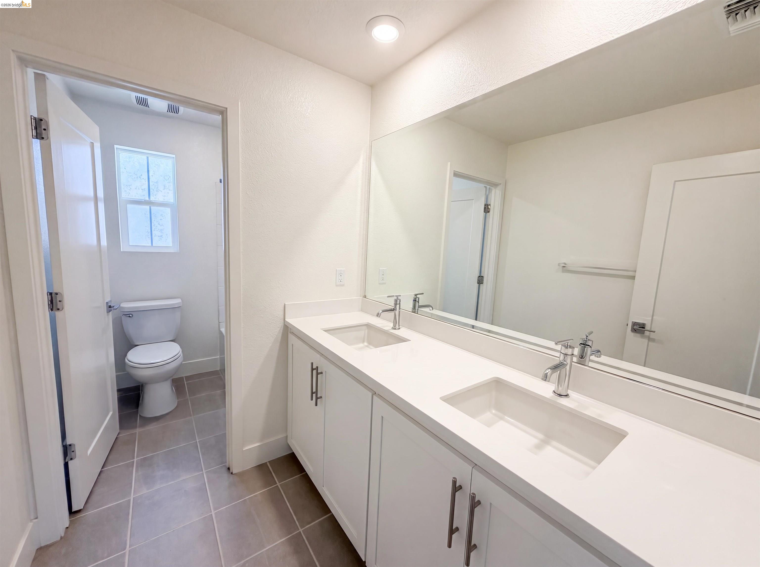 9034 Rudder Way Newark, CA 94560 - Photo 21 of 38 Double vanity with integrated rectangular sinks and chrome faucets