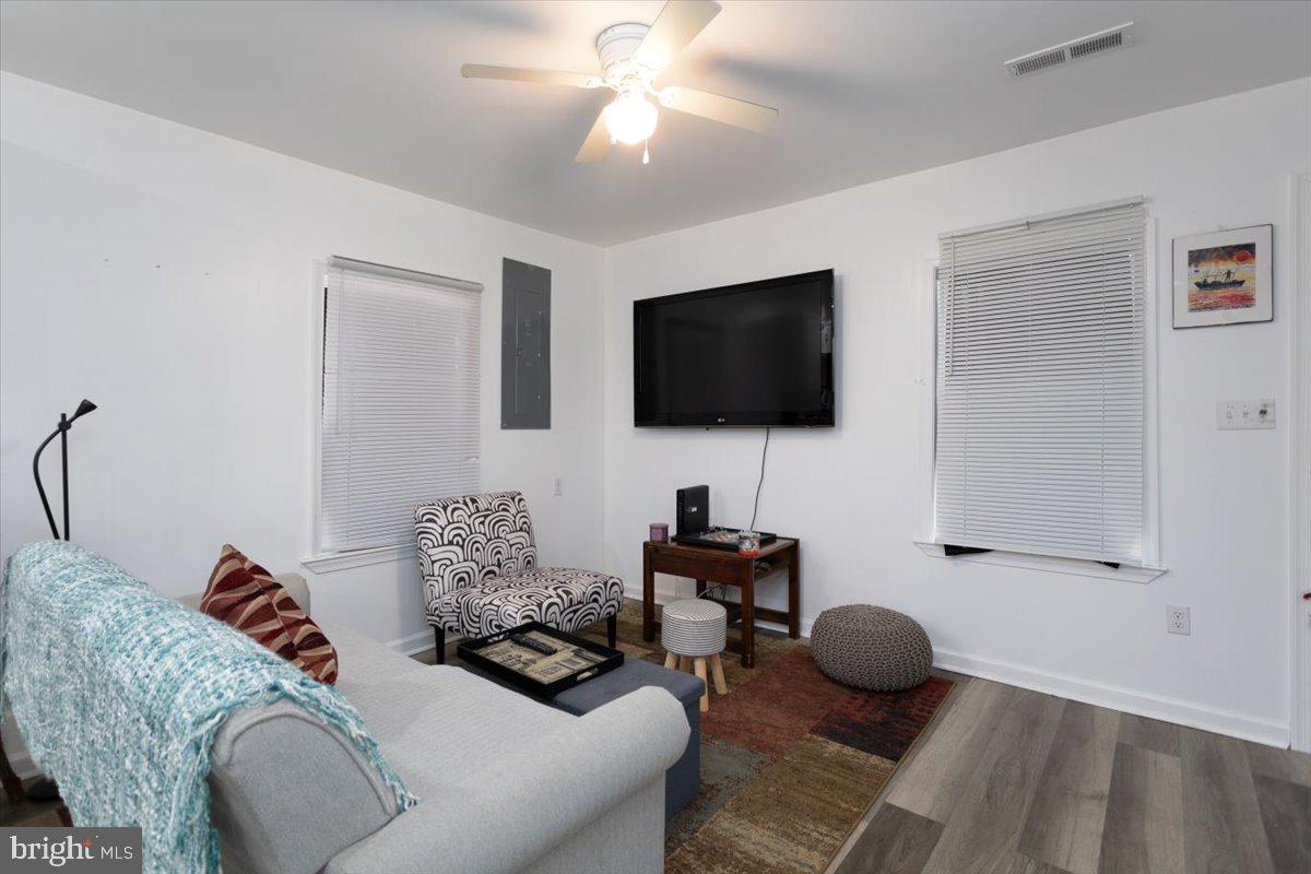 728 Race Street Cambridge, MD 21613 - Photo 3 of 14 a living room with furniture and a flat screen tv