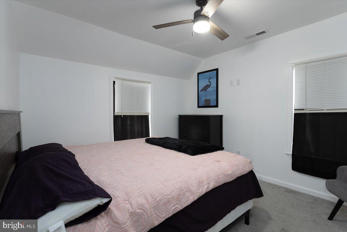728 Race Street Cambridge, MD 21613 - Photo 9 of 14 a bedroom with a bed and a television