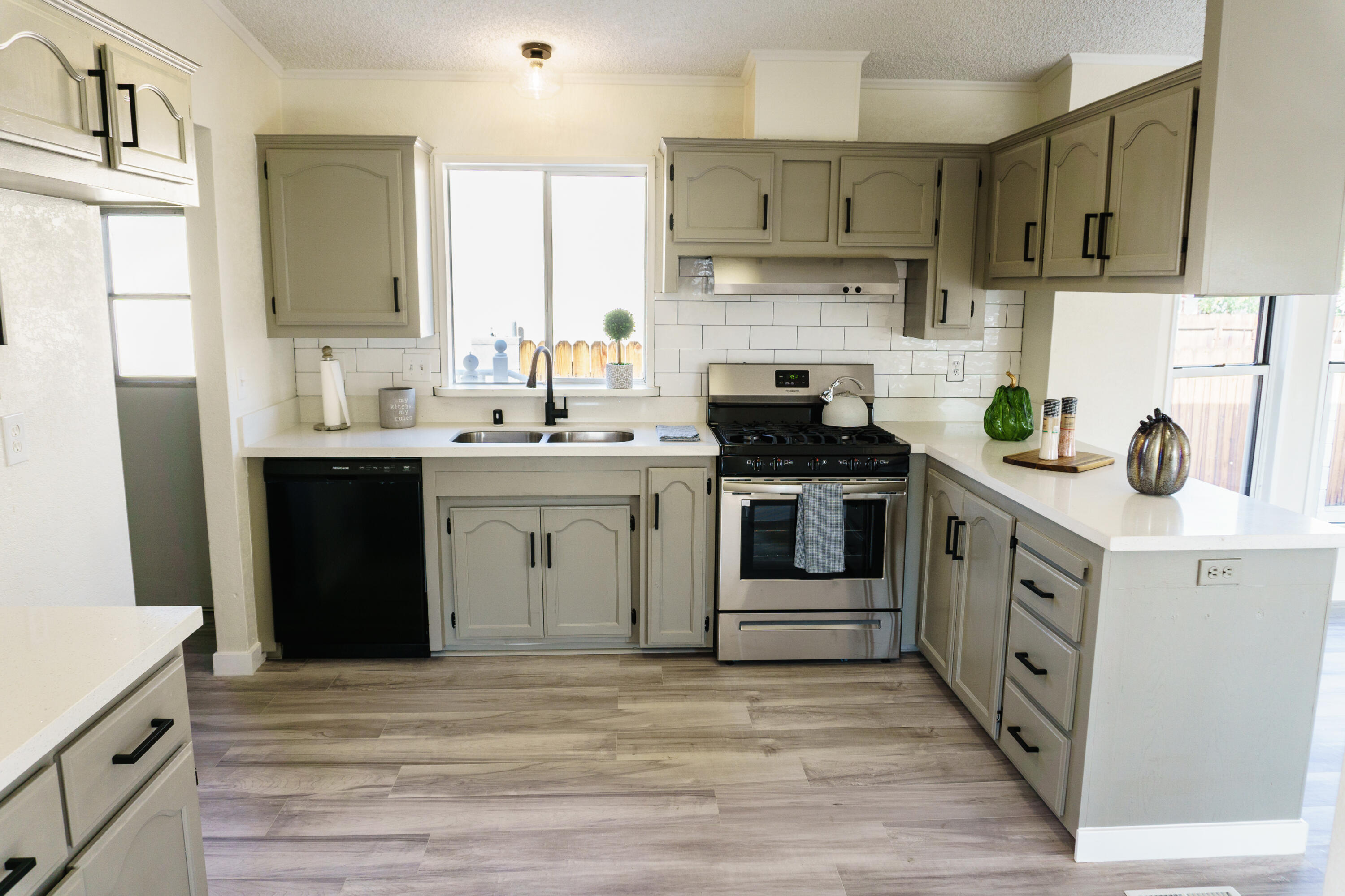 1301 Wayne Street Ridgecrest, CA 93555 - Photo 3 of 26 a kitchen with stainless steel appliances a stove a sink and a refrigerator