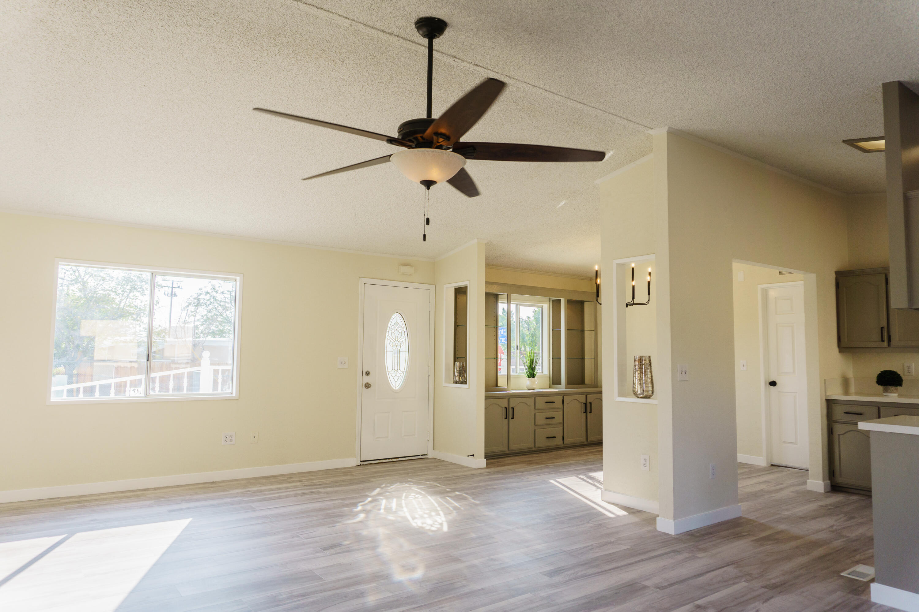 1301 Wayne Street Ridgecrest, CA 93555 - Photo 8 of 26 a view of a room with wooden floor and a ceiling fan