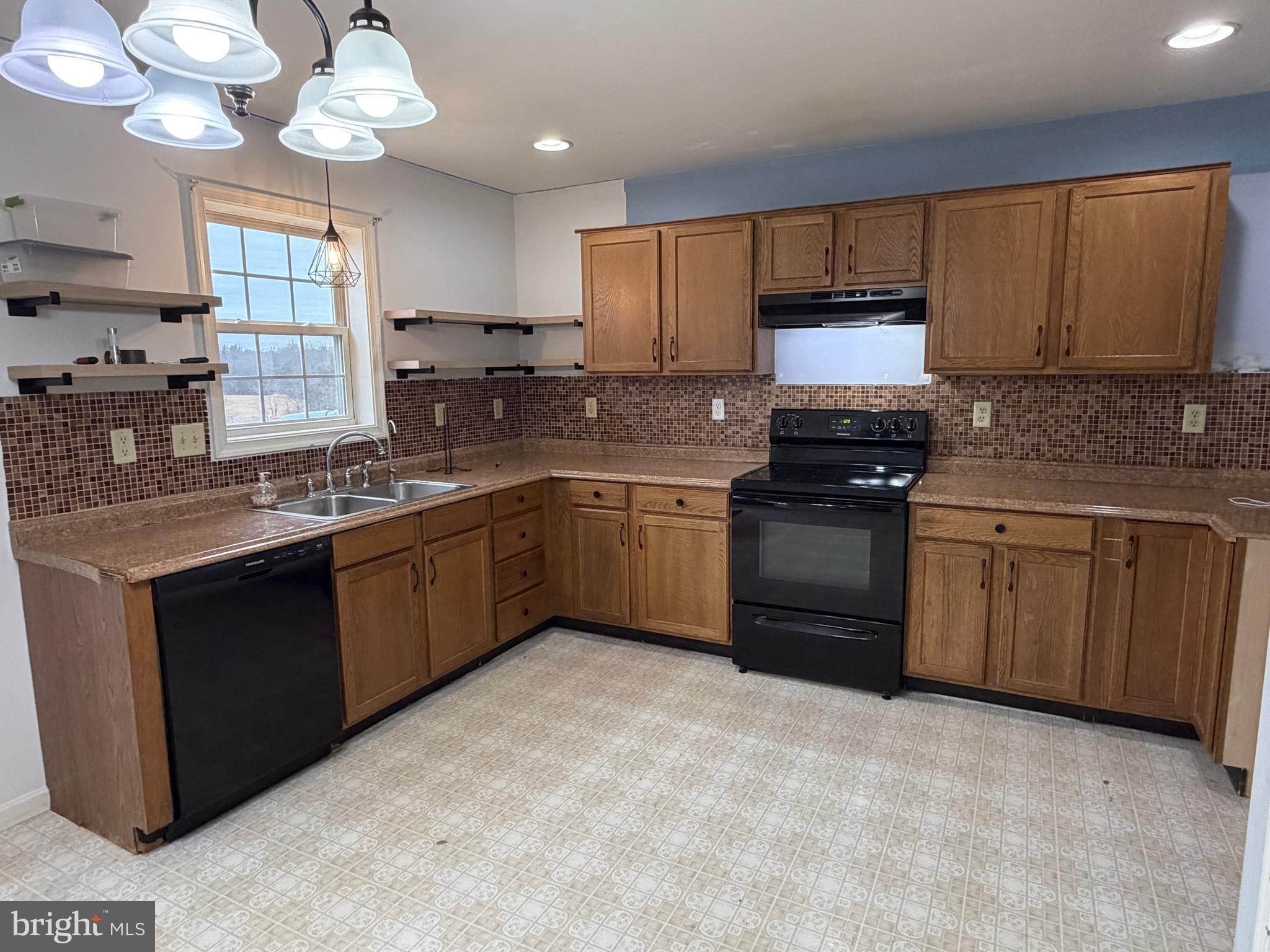 4 Subdivision Road Newville, PA 17241 - Photo 37 of 78 a kitchen with cabinets a window and stainless steel appliances
