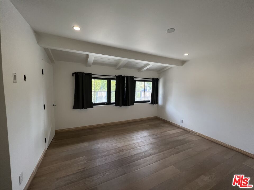 3360 Wrightview Place Studio City, CA 91604 - Photo 16 of 16 a view of an empty room with wooden floor and a window