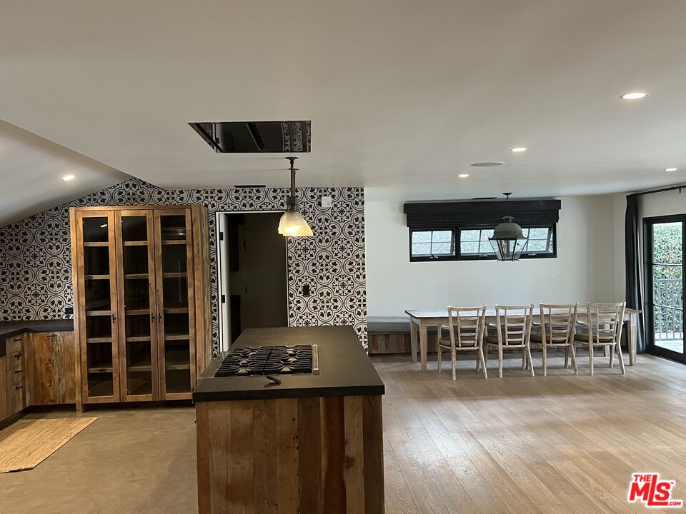 3360 Wrightview Place Studio City, CA 91604 - Photo 5 of 16 a dining room with wooden floor a glass table and chairs