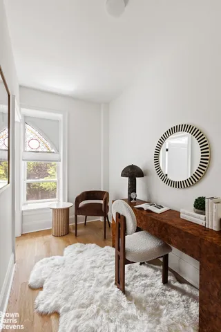 a bedroom with a bed table closet and two couches