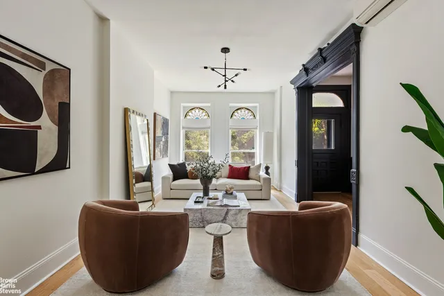 a living room with furniture a mirror and a window