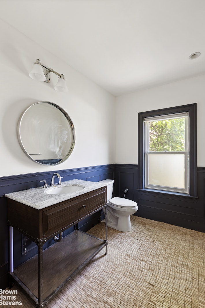 271 Decatur Street Brooklyn, NY 11233 - Photo 7 of 15 a bathroom with a toilet a sink and a mirror