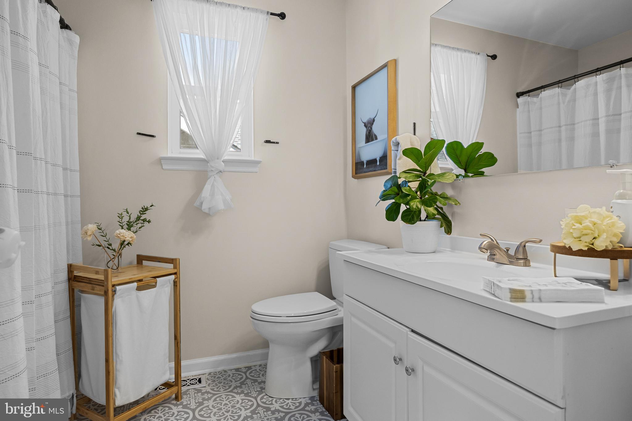 188 Carlisle Road Audubon, NJ 08106 - Photo 13 of 40 a bathroom with a sink toilet and a mirror