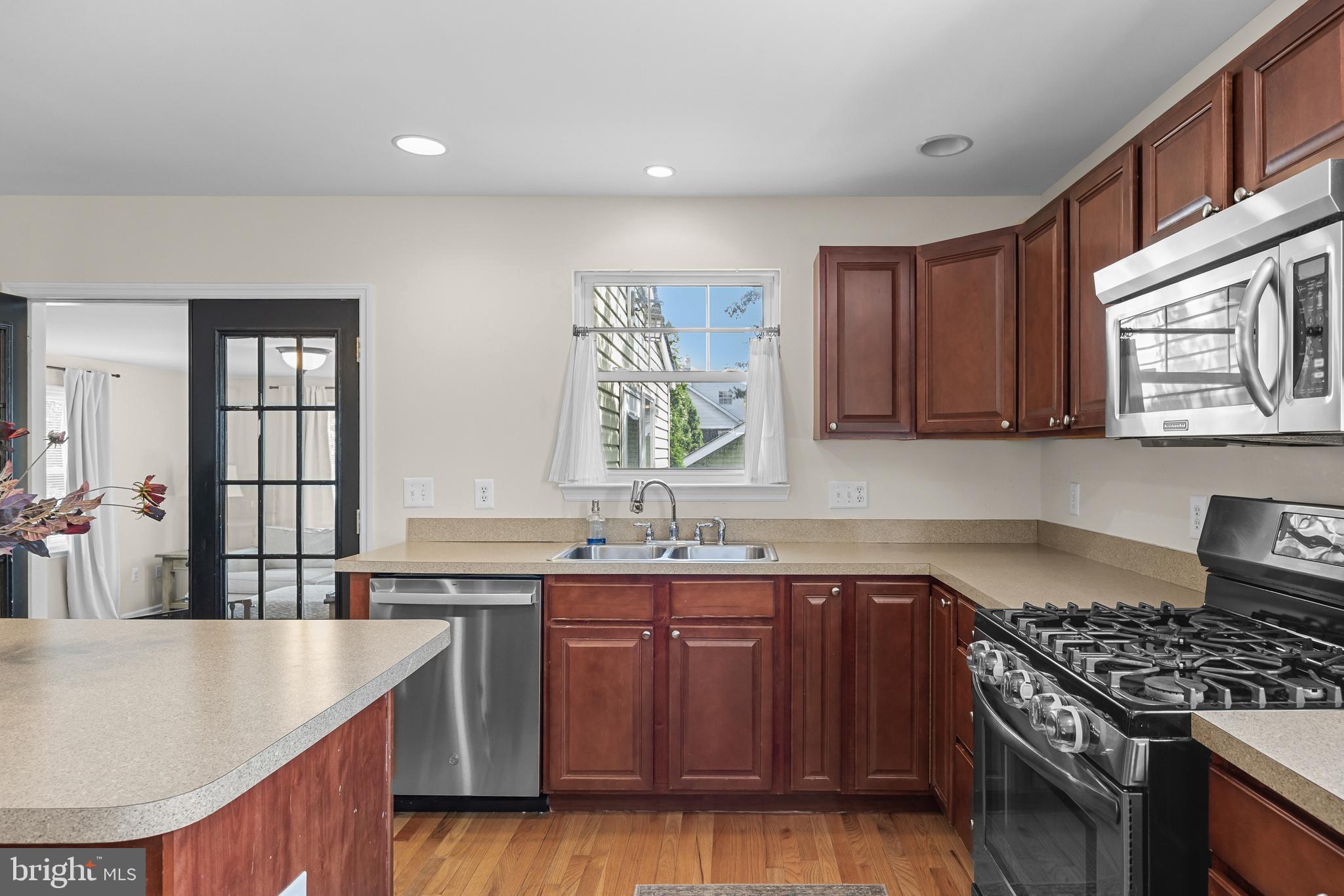 188 Carlisle Road Audubon, NJ 08106 - Photo 15 of 40 a kitchen with stainless steel appliances granite countertop a sink stove and cabinets