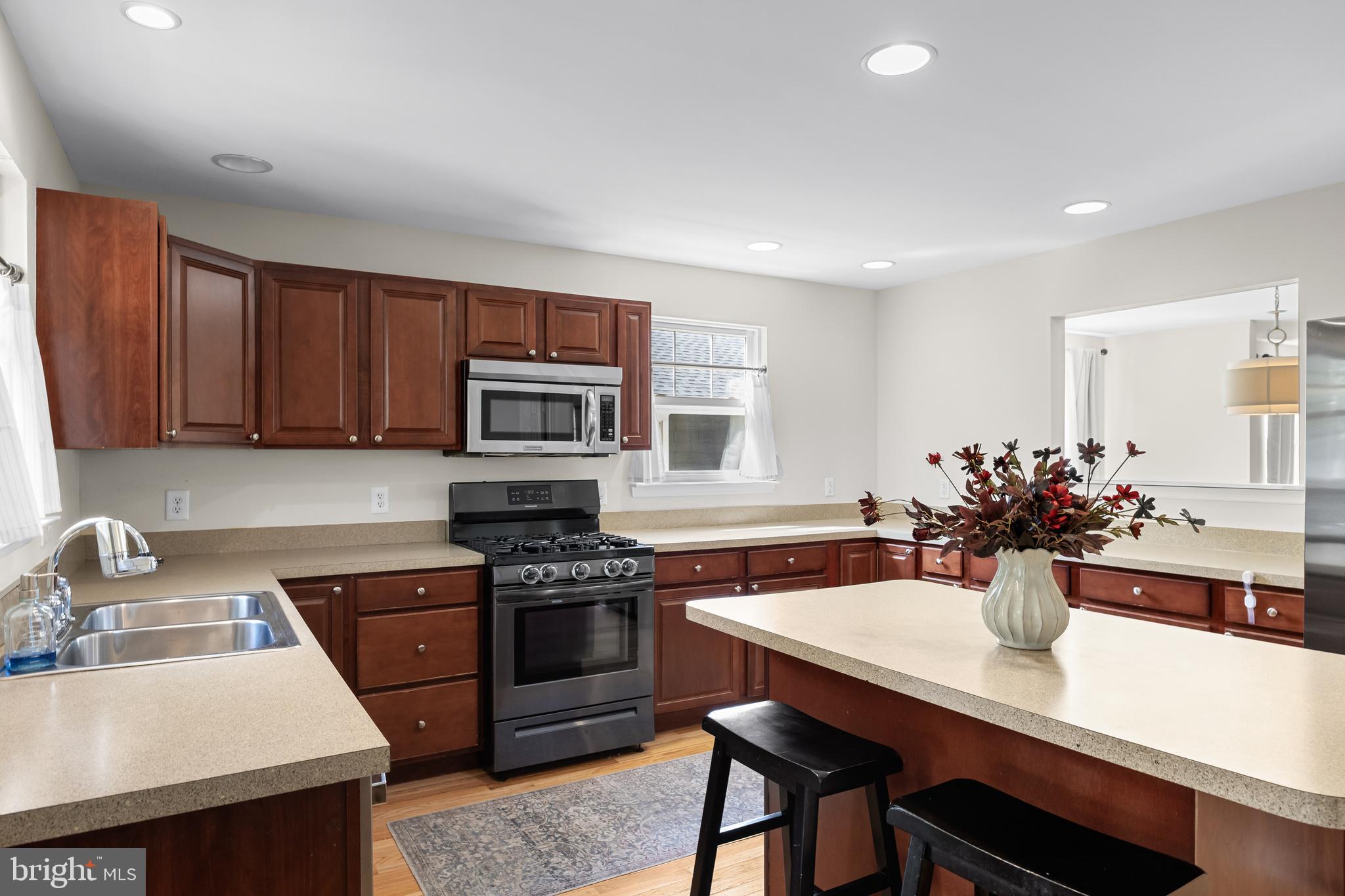 188 Carlisle Road Audubon, NJ 08106 - Photo 17 of 40 a kitchen with a sink stove and microwave