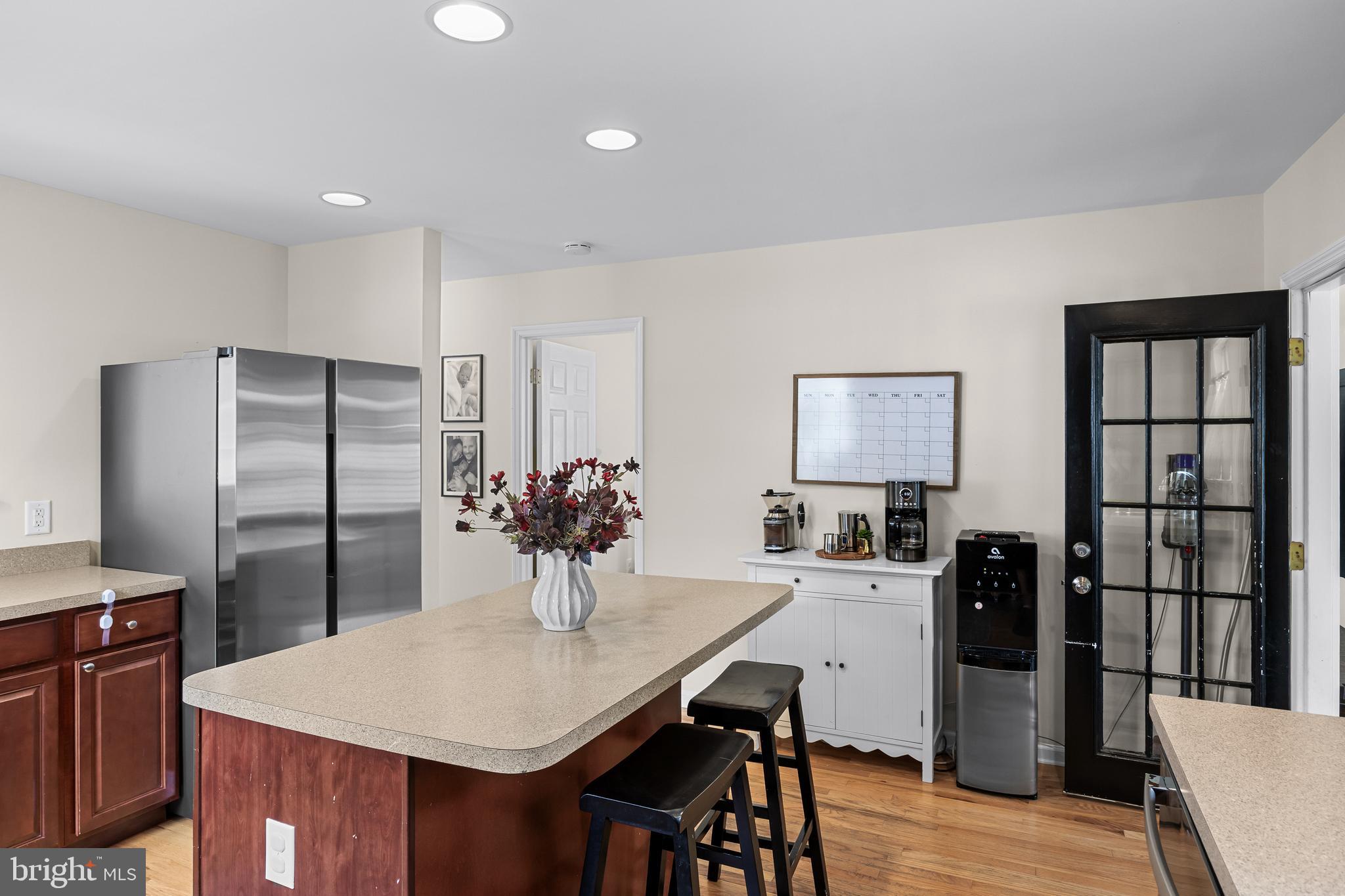 188 Carlisle Road Audubon, NJ 08106 - Photo 18 of 40 a kitchen with stainless steel appliances a dining table chairs and refrigerator