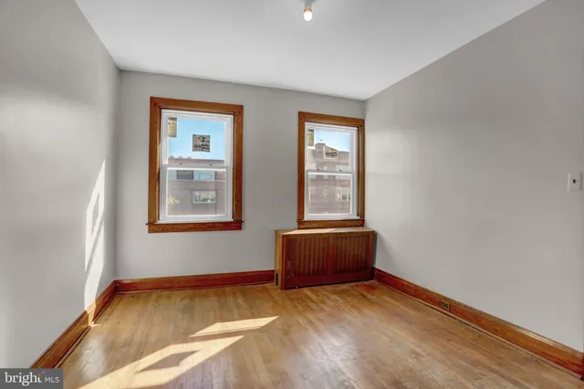 a view of room with window and wooden floor