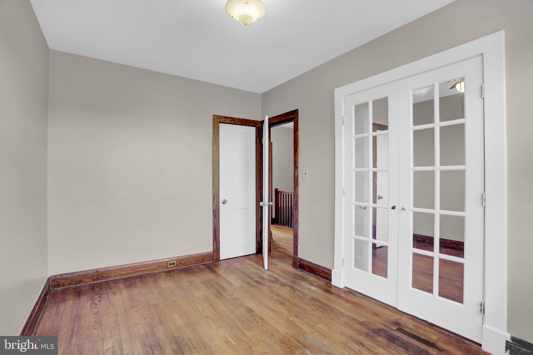 714 Rappolla Street Baltimore, MD 21224 - Photo 19 of 36 an empty room with wooden floor and windows