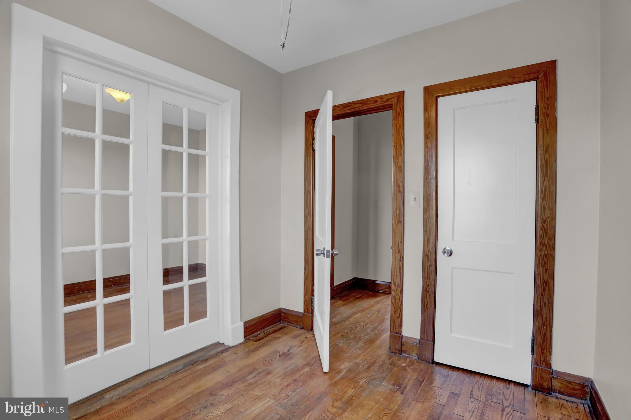 714 Rappolla Street Baltimore, MD 21224 - Photo 21 of 36 an empty room with wooden floor and windows