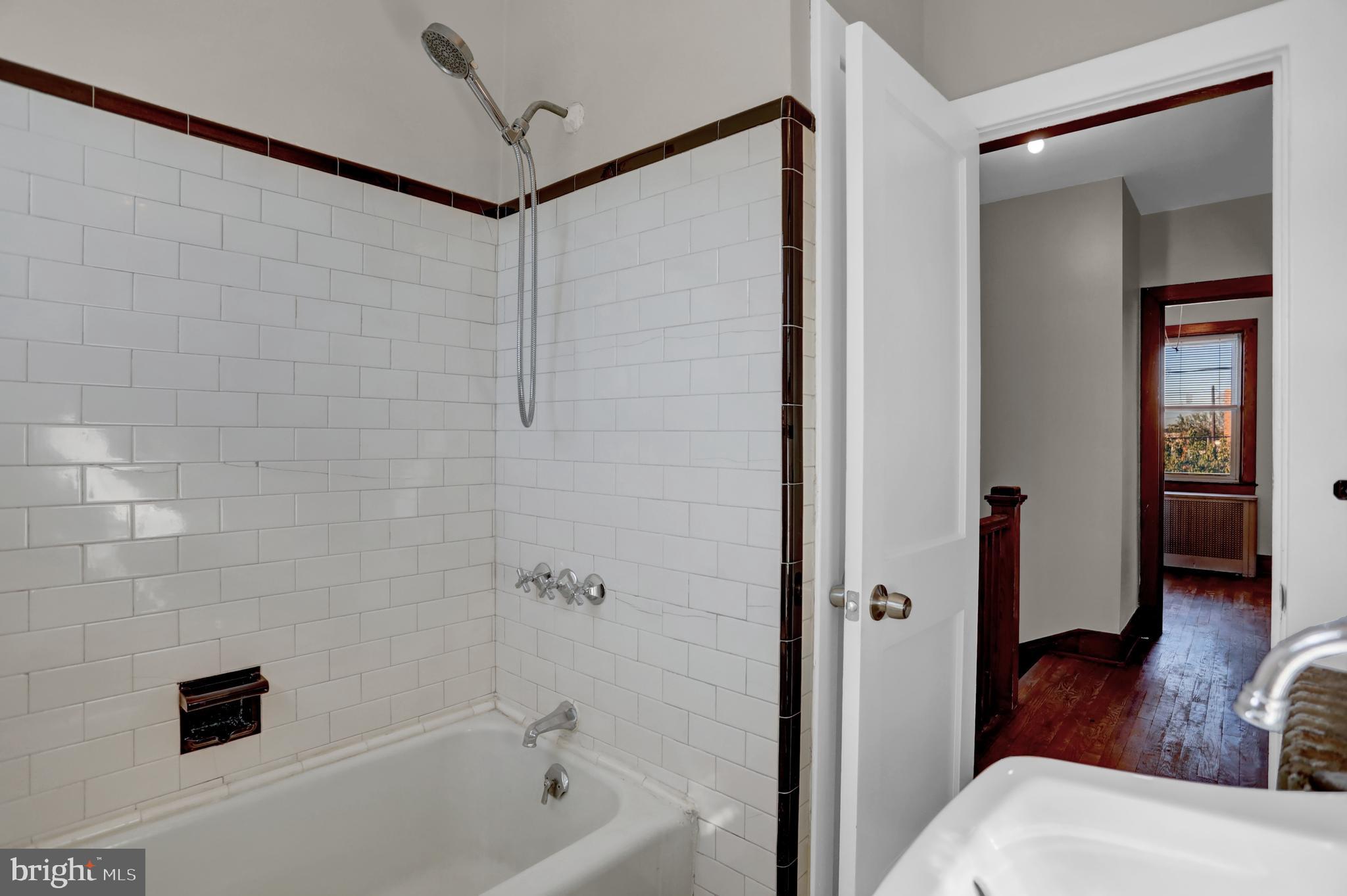 714 Rappolla Street Baltimore, MD 21224 - Photo 23 of 36 a bathroom with a bathtub and a shower