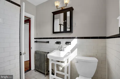 a bathroom with a toilet sink and mirror