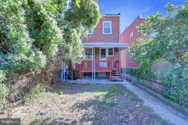 a view of a house with a yard porch and sitting area