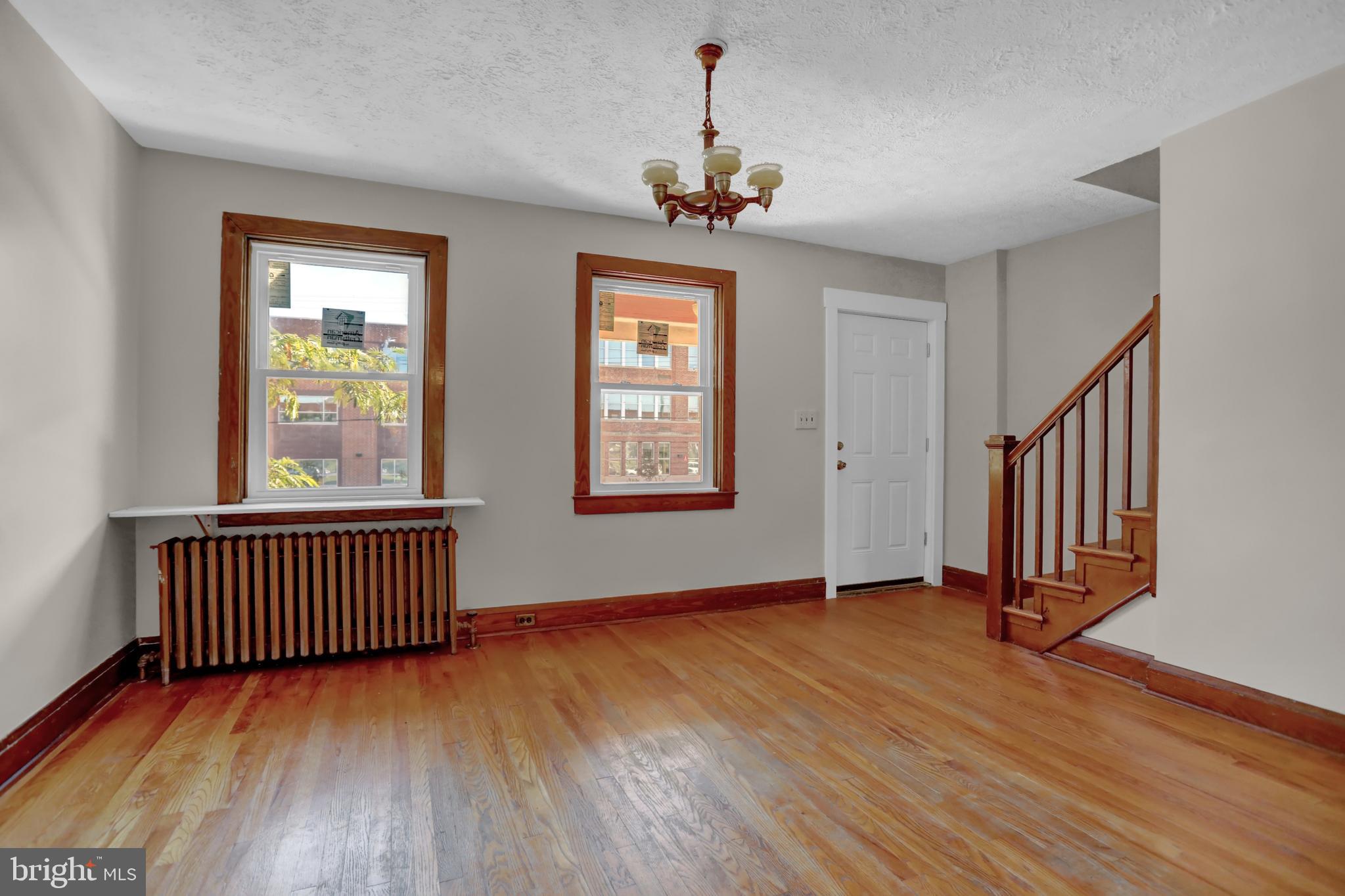 714 Rappolla Street Baltimore, MD 21224 - Photo 9 of 36 a view of an empty room with wooden floor and a window