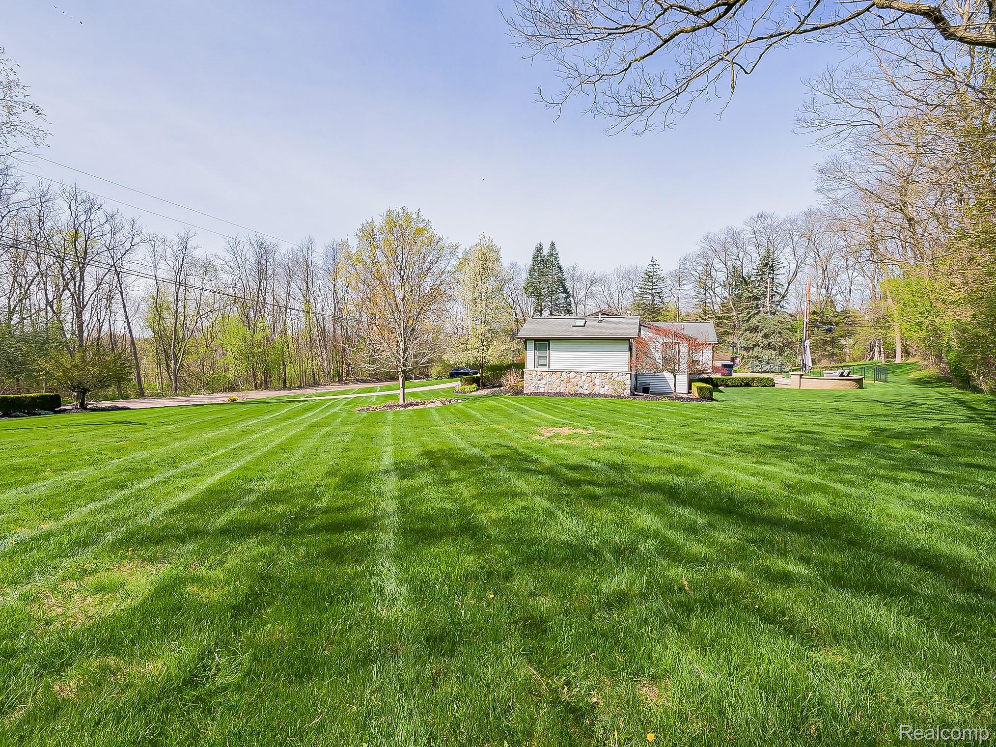 3720 East Clarkston Road Oakland, MI 48363 - Photo 46 of 60 View of green lawn featuring view of scattered trees