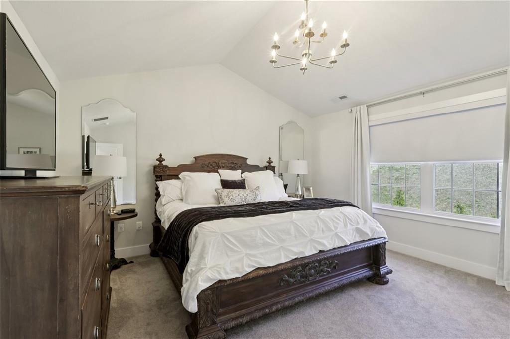 216 Hickory Lane Mars, PA 16046 - Photo 23 of 50 a bedroom with a bed and a chandelier