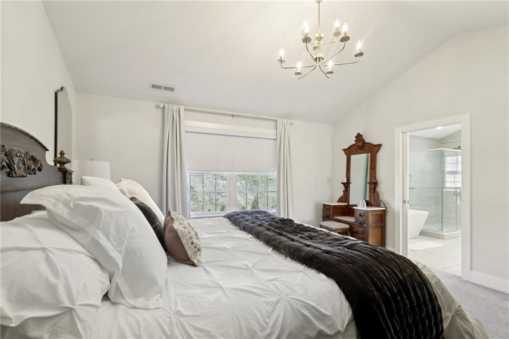 216 Hickory Lane Mars, PA 16046 - Photo 25 of 50 a bedroom with a bed and a chandelier