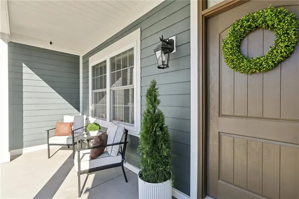 a front view of a house with garden and patio