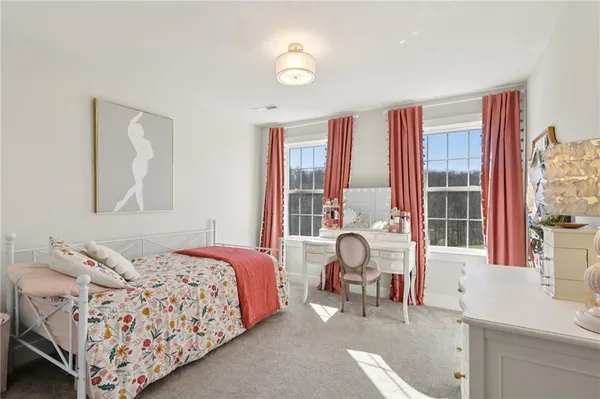 a bedroom with a bed and a television