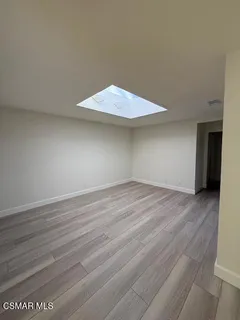 an empty room with wooden floor