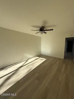 a view of a room with wooden floor