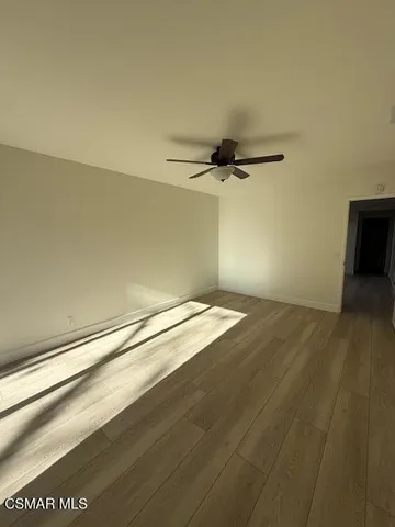 a view of a room with wooden floor