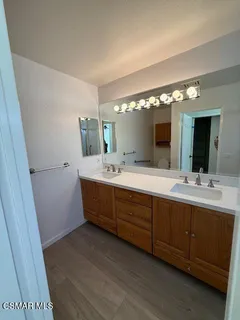 a bathroom with a double vanity sink and mirror