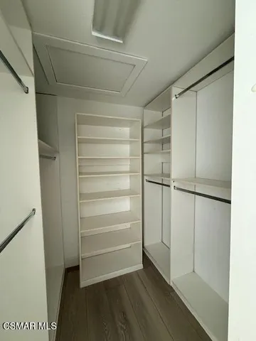 a view of walk in closet with empty racks