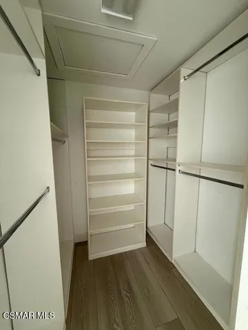 a view of walk in closet with empty racks