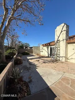 a view of an empty room and with kitchen view