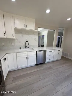 a kitchen with a sink and cabinets