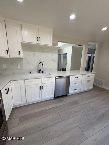 a kitchen with a sink and cabinets